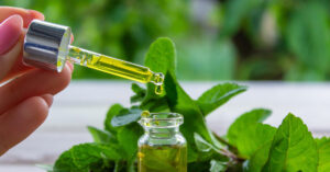 The mint extract in a small jar. Selective focus.