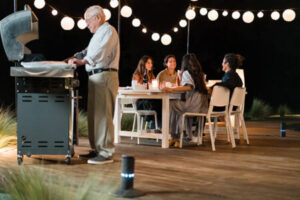 Family BBQing on the back patio during the evening | Florida Pest Control serving