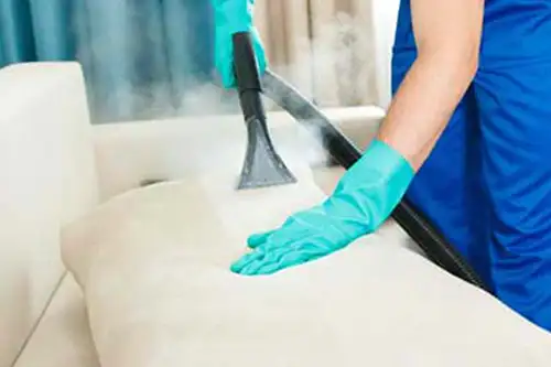 Person steaming a bed sheet - Florida Pest Control, Gainesville FL